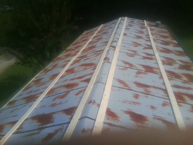 Rusted metal roof panels with new wood purlins before replacement — Storm Damage Roof Repair in Maple Shade by Roofing Brothers