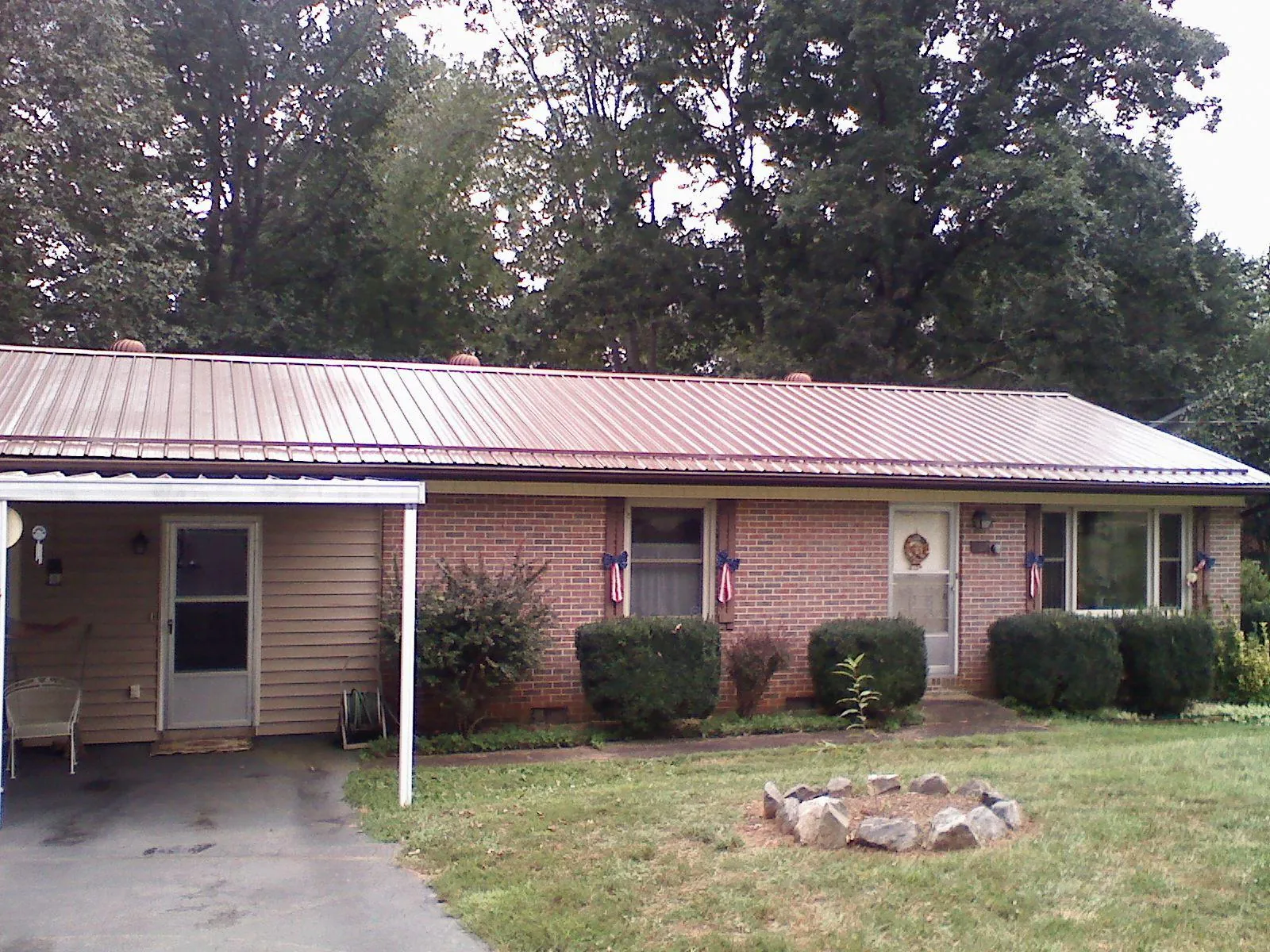 Bronze metal roof and carport on a brick ranch home — Roof Repair work by our crew in Maple Shade